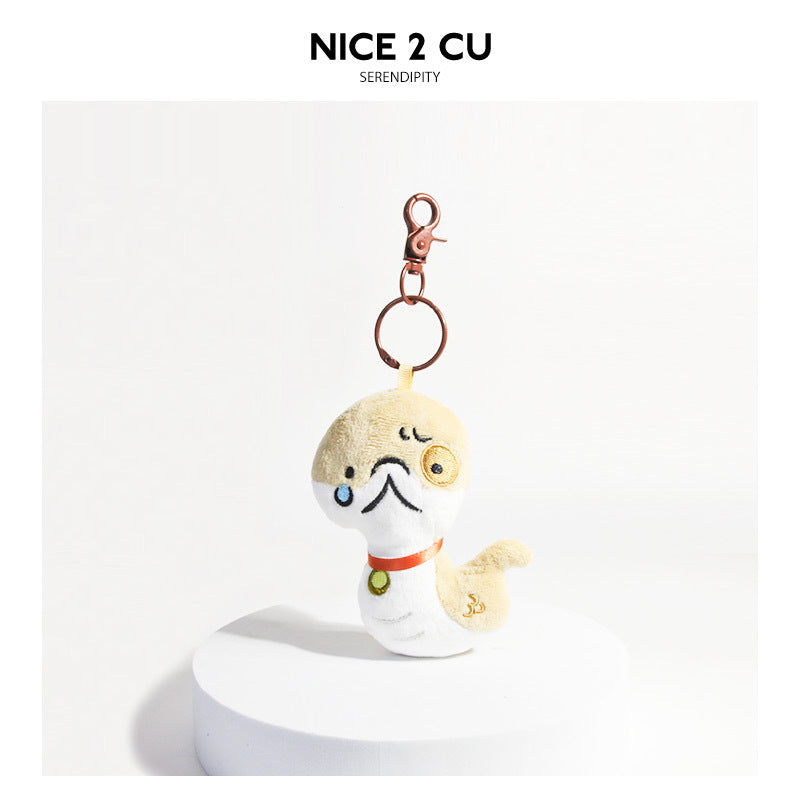 Cartoon dog plush keychain charm with tearful expression, cream and white body, orange collar, and gold-tone clasp