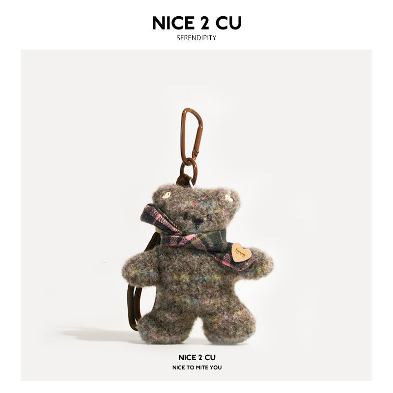 Gray mottled plush bear keychain charm with dark plaid scarf, heart tag, and clip hardware