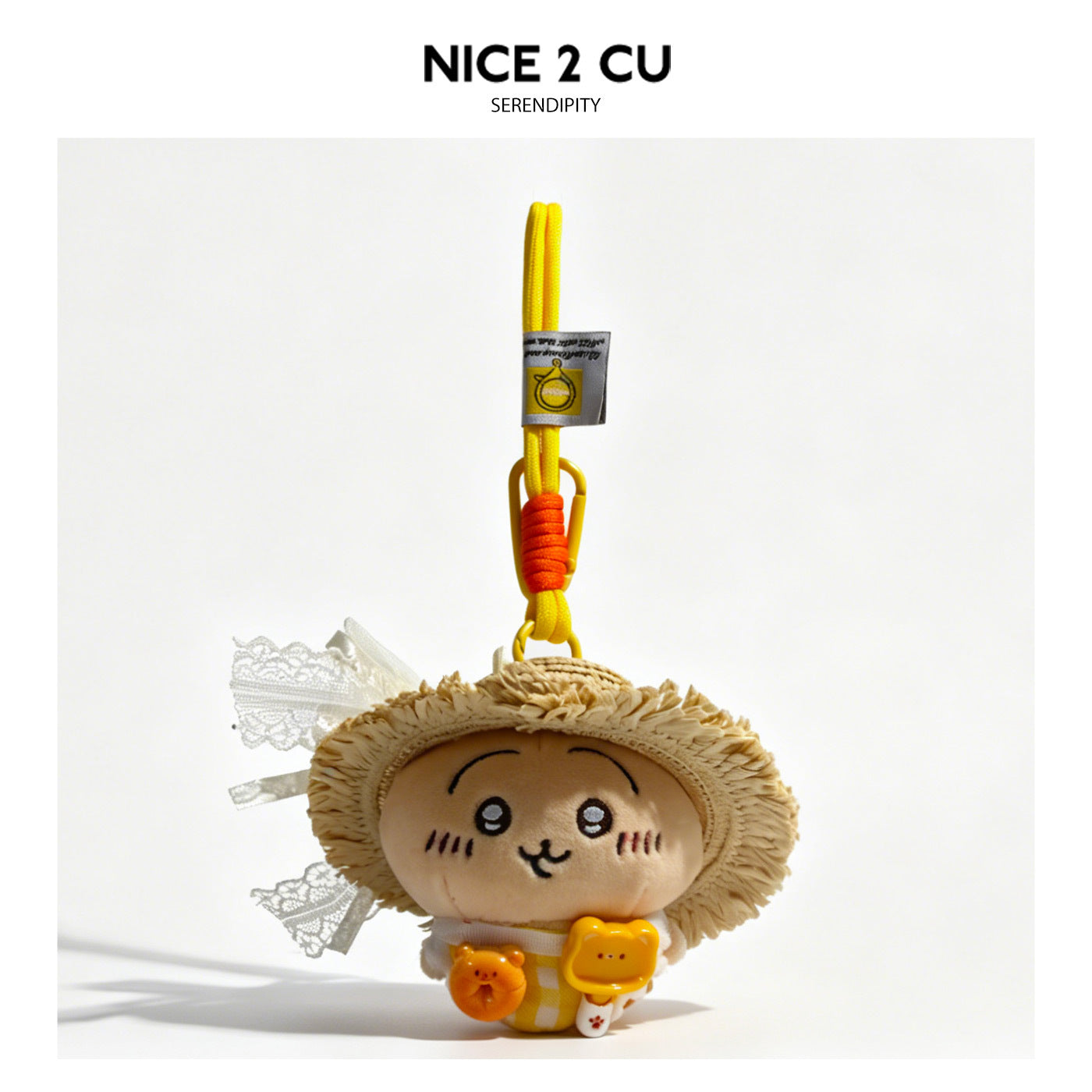 Kawaii cat plush bag charm wearing an oversized fringed straw hat with white lace bow and braided orange-yellow lanyard clip