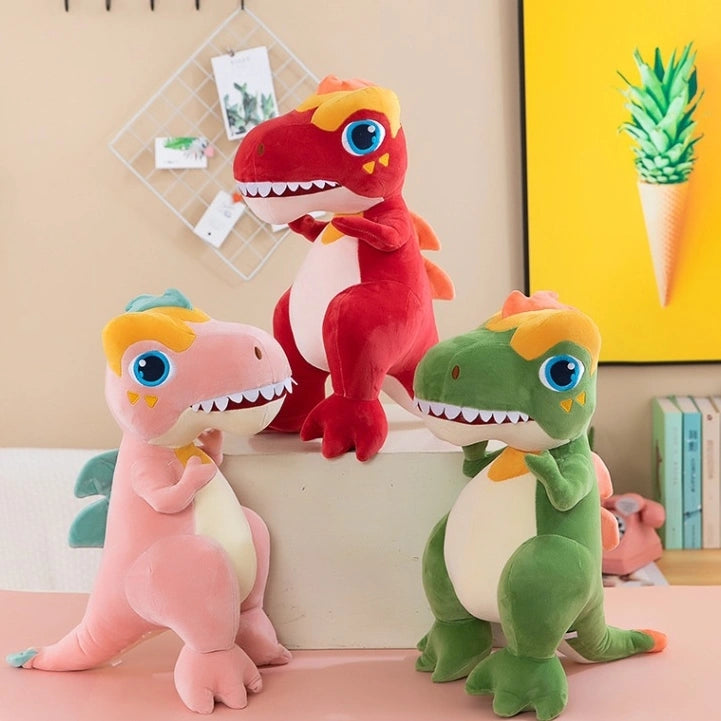 Three ZoDoll T Rex Plush Dinosaur Soft Stuffed Animal Toys—pink, red, and green—are displayed on a white surface in a colorful room. Each cute 40cm or 50cm plush T Rex adds charm to the playful décor.