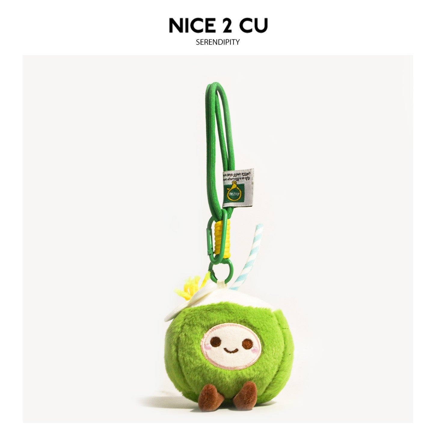 Green kawaii coconut plush keychain charm with embroidered smiling face, striped straw, and carabiner clip