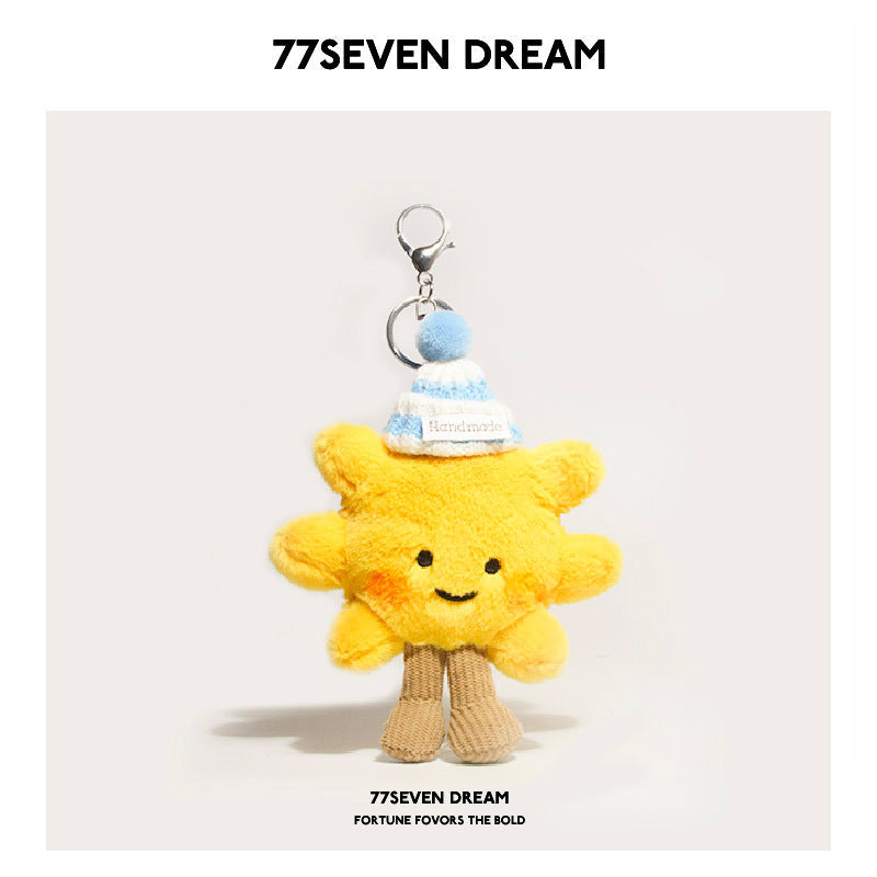 Yellow sunflower plush charm wearing a blue-and-white striped knit hat with blue pom-pom