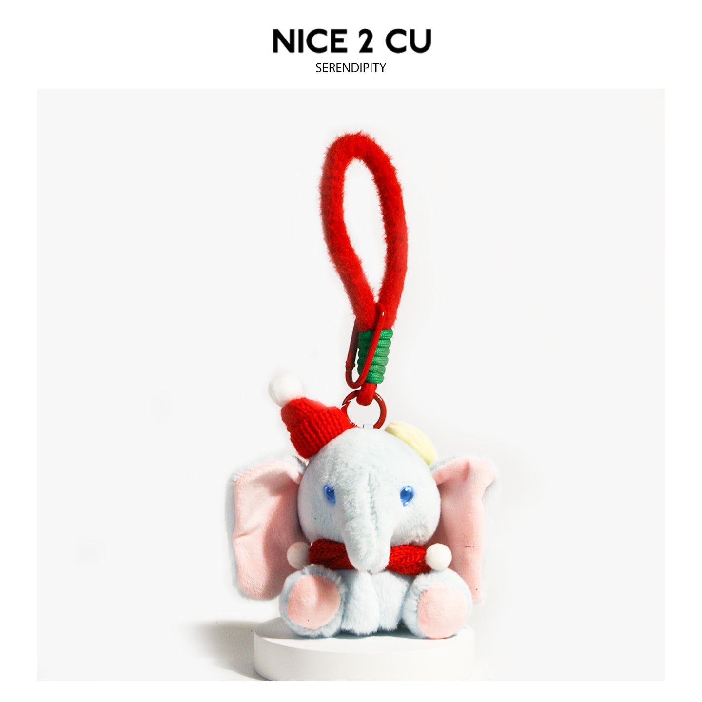 Blue-grey kawaii elephant plush charm wearing a red knitted hat and scarf with white pompoms and a red clip loop