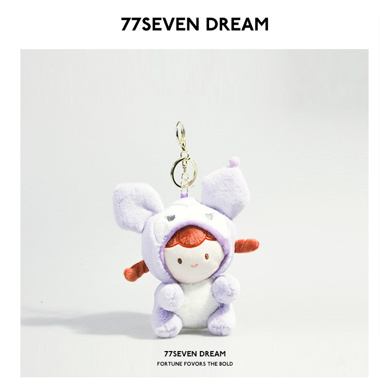 Kawaii plush keychain charm with girl doll face in a lavender animal hood costume and gold ring attachment