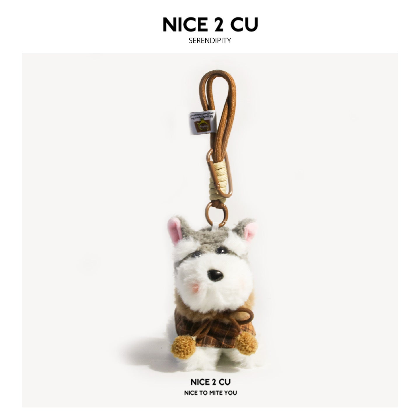 Schnauzer plush keychain charm wearing a brown plaid cape with cream pom-pom ties and brown clip lanyard