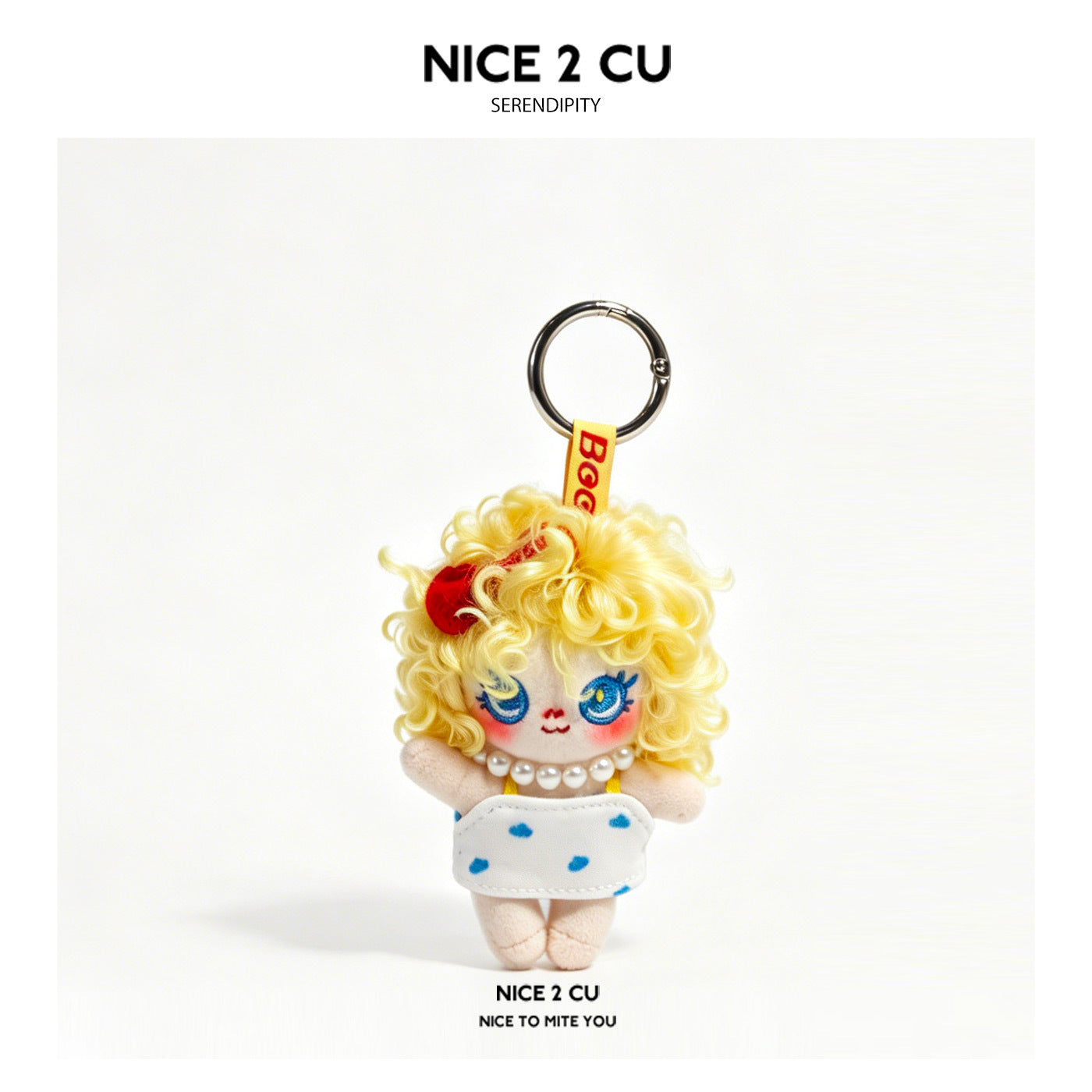 Grumpy girl plush doll keychain charm with curly blonde hair and white dress with blue dots on silver split ring
