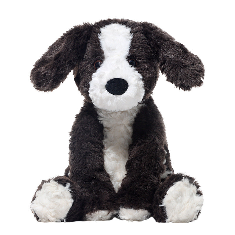 The JOOKI 24cm Black and White Puppy Plush Toy is a soft stuffed dog with floppy ears, sitting upright against a plain white background—adorable and perfect for cuddles.