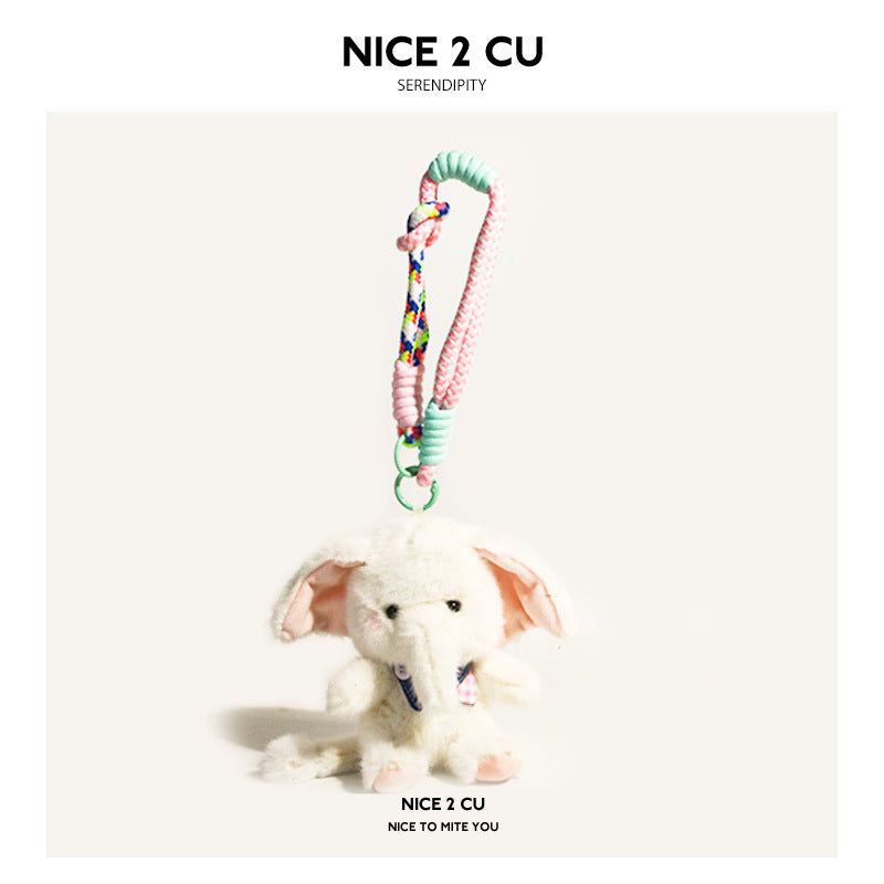 White plush elephant charm with pink denim-style bib attached to a mint and multicolor rope strap