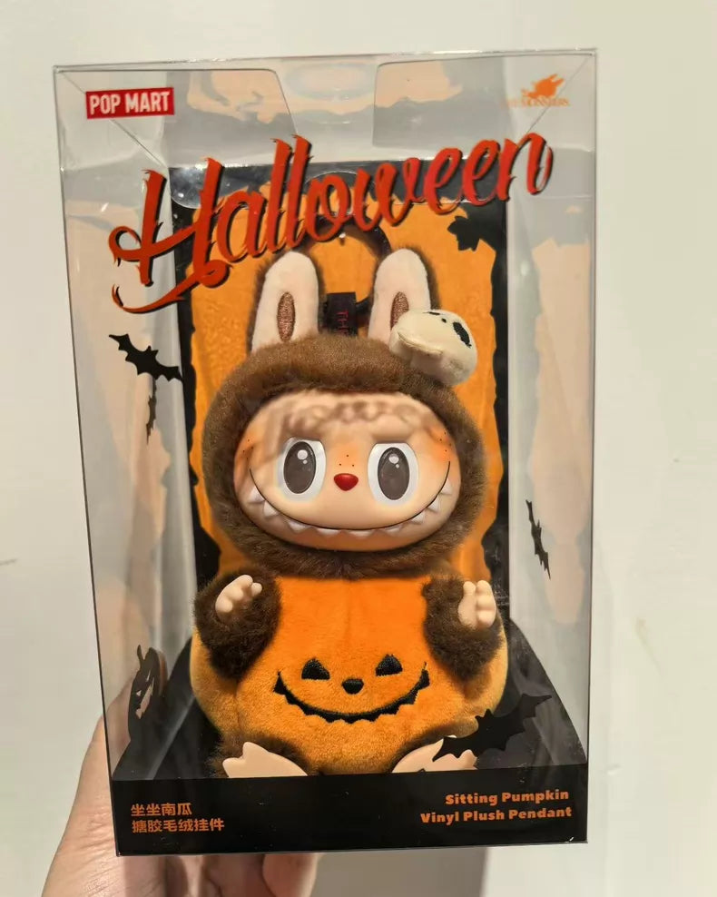 The POP MART THE MONSTERS – Happy Halloween Party Labubu 15cm Vinyl Plush Keychain (Pumpkin Edition) is a cute bunny-eared pumpkin toy in Halloween packaging—ideal as a keychain or gift for Labubu fans.