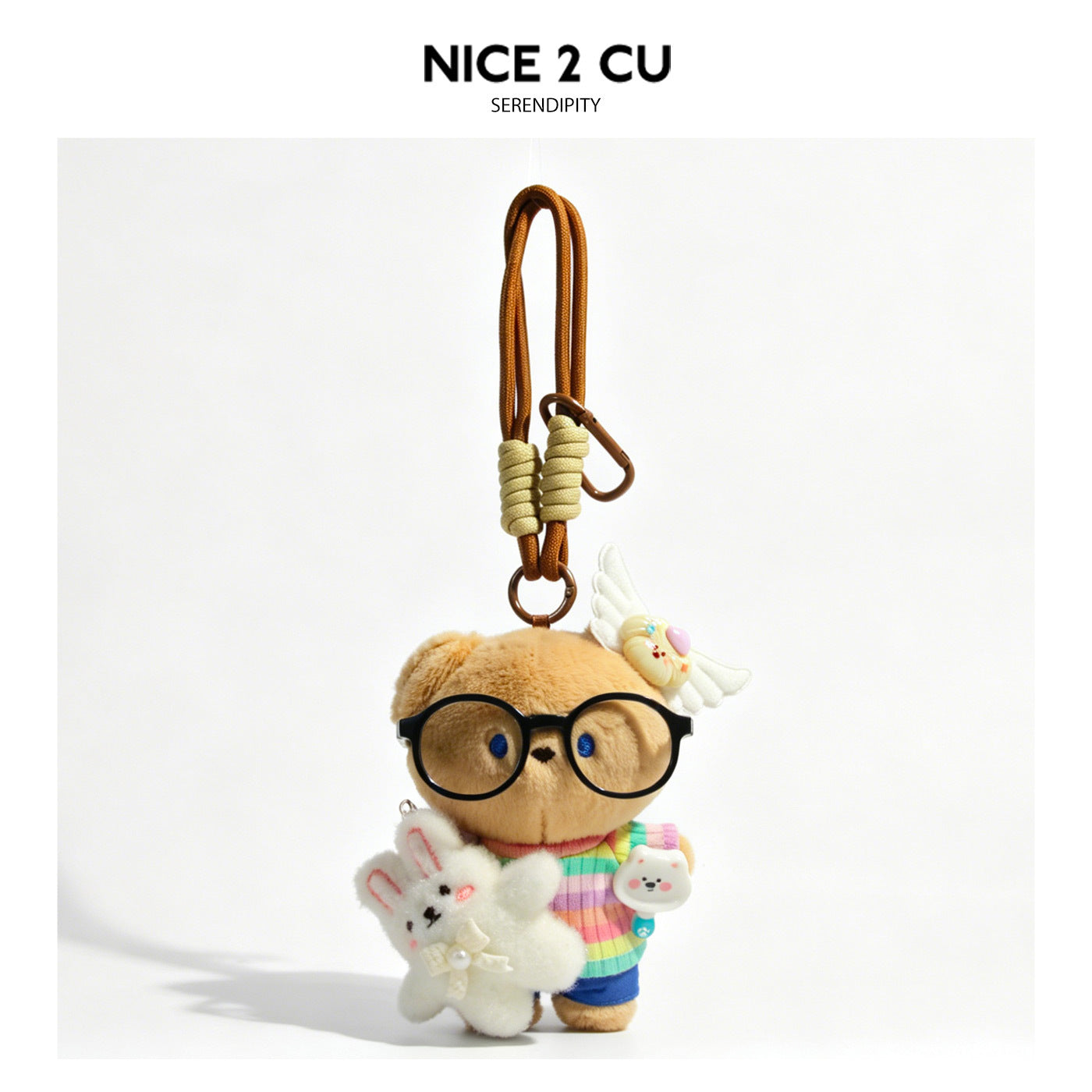 Plush brown bear charm with round black glasses, rainbow-striped top, and white rabbit accessory on brown cord loop