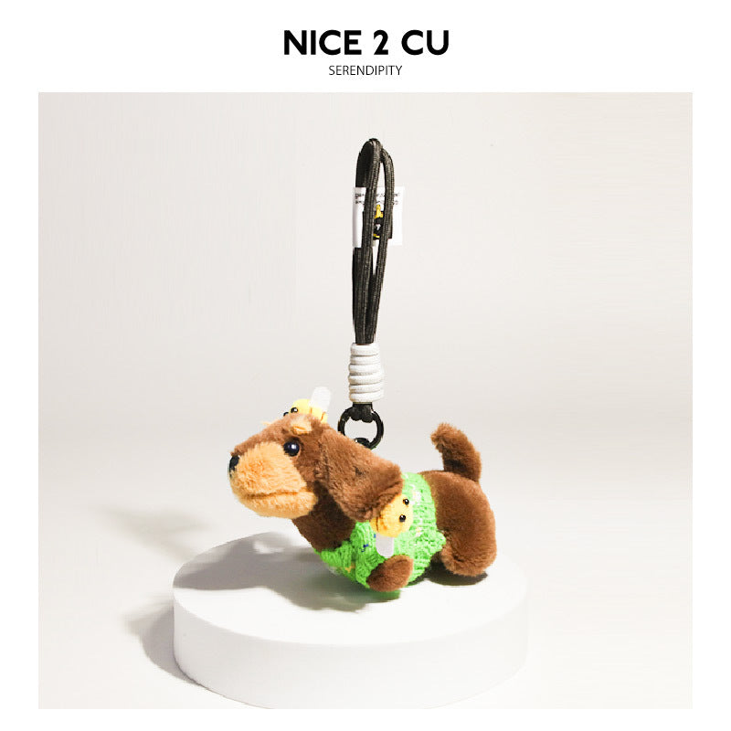 Plush dachshund charm in a bright green knit sweater with bee decorations and hanging strap