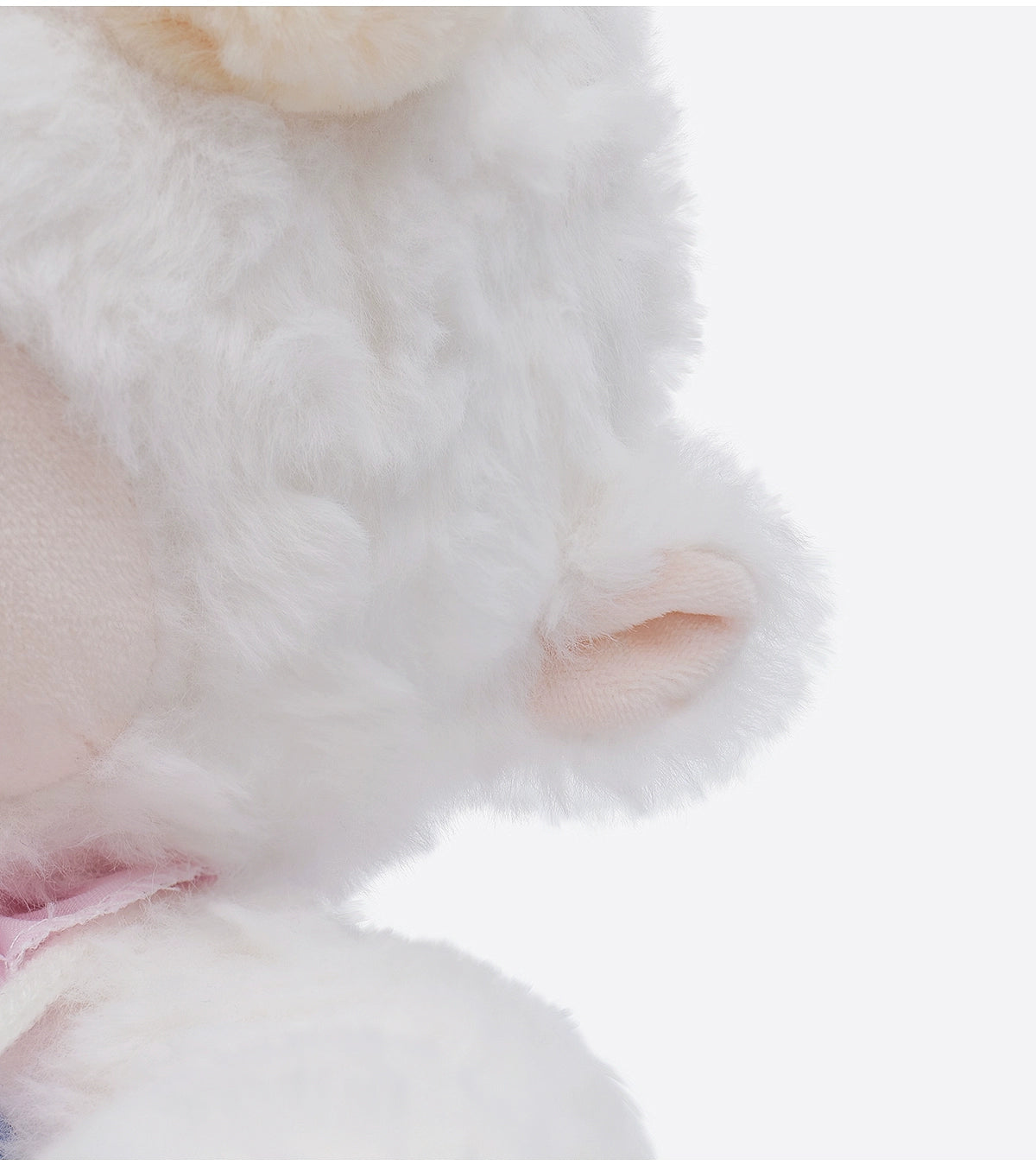 Close-up of the ZEIO Fashion Sheep Plush Toy 29cm—a cute dressed lamb doll with soft white fur, pink inner ears, and part of a pink ribbon accessory visible around its neck.