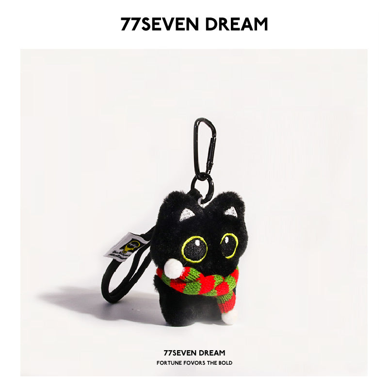 Black cat plush keychain with large yellow-outlined eyes wearing a red-and-green striped scarf