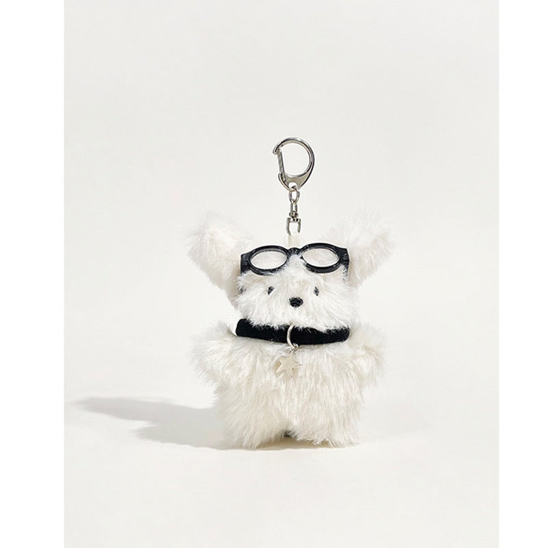Fluffy white dog plush keychain charm with round black glasses and star-shaped pendant