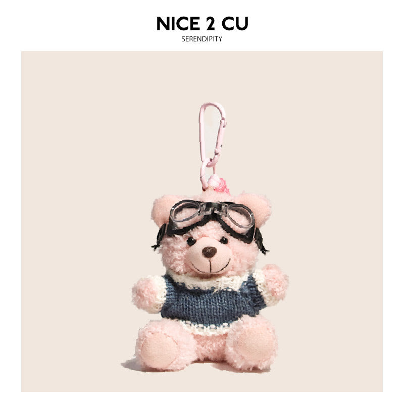 Pink teddy bear keychain pendant with blue-and-white striped knit sweater and black aviator goggles