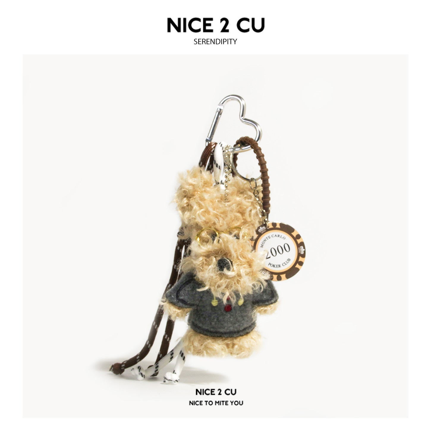 Beige curly-fur dog plush charm wearing a grey top, with heart-shaped silver carabiner clip and Monte Carlo poker chip hang t