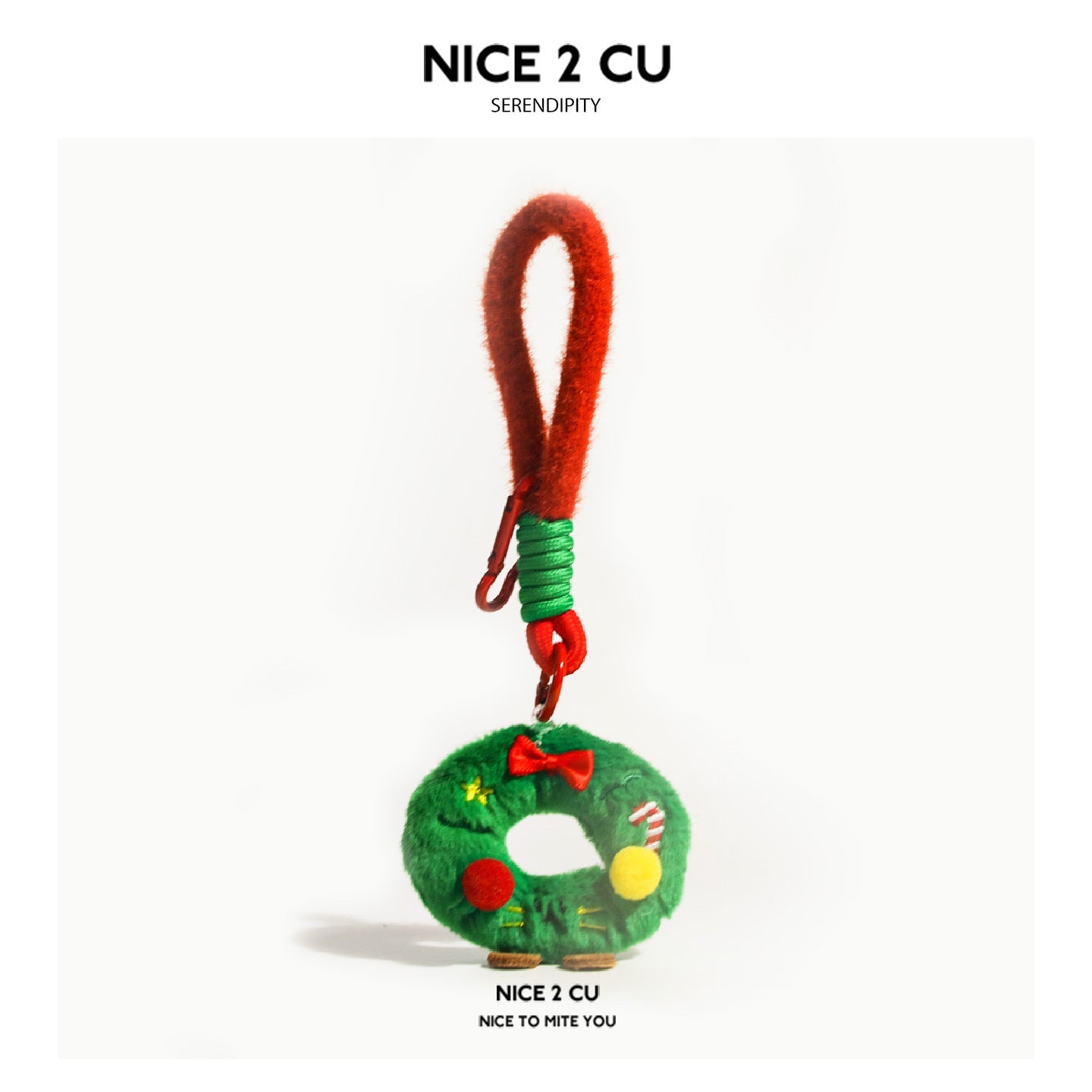 Kawaii Christmas wreath plush charm with red bow, ornaments, candy cane detail, and small brown feet on a red clip loop