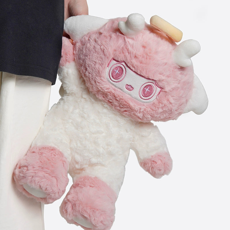 Person holding the ZEIO Angel Lamb Plush Toy 30cm— a soft cherubic sheep with pink and white fur, round face, small horns, embroidered pink eyes and mouth, plus a cute halo and wings.