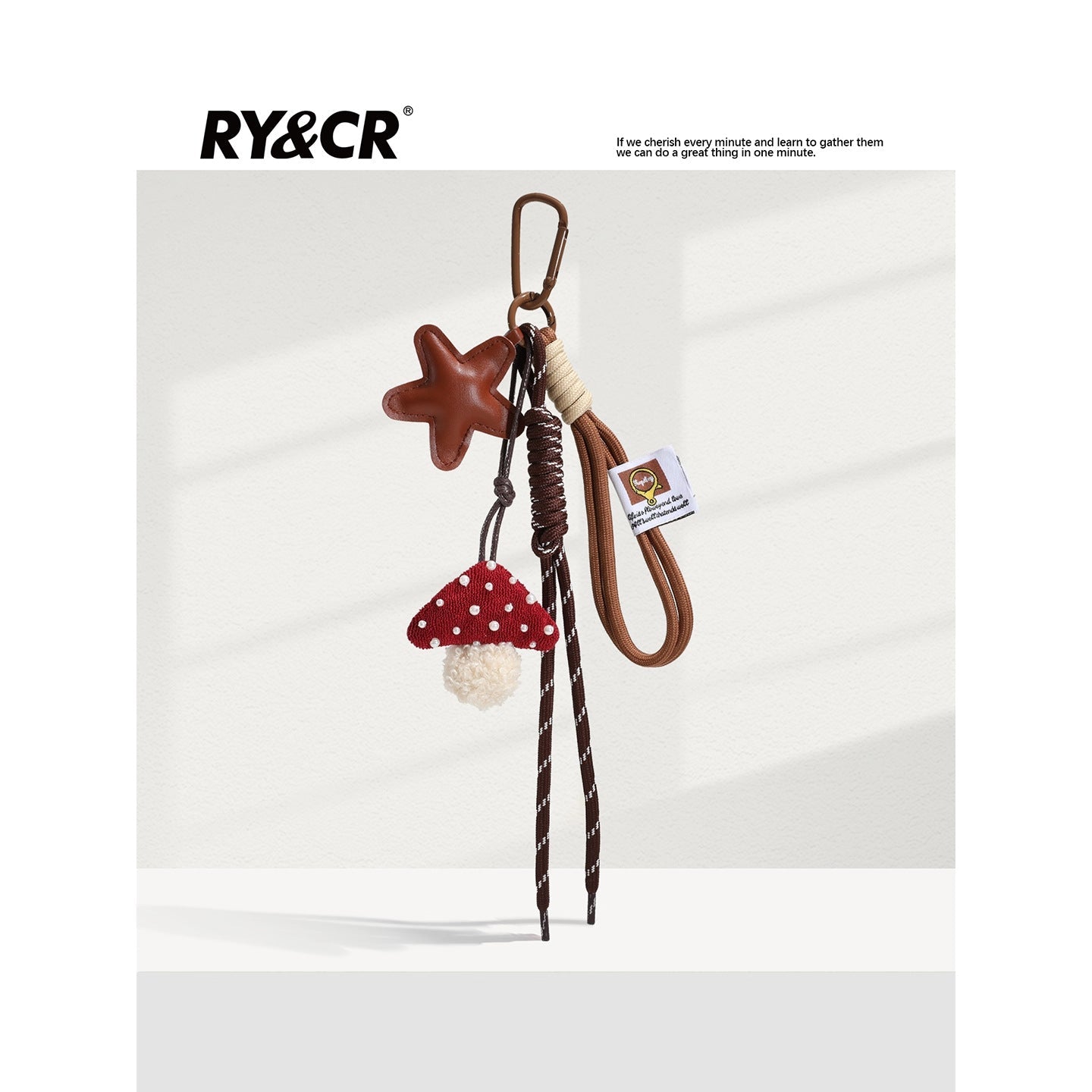 Red mushroom fabric charm with white pearl dots and tan star accent on brown braided lanyard and carabiner clip