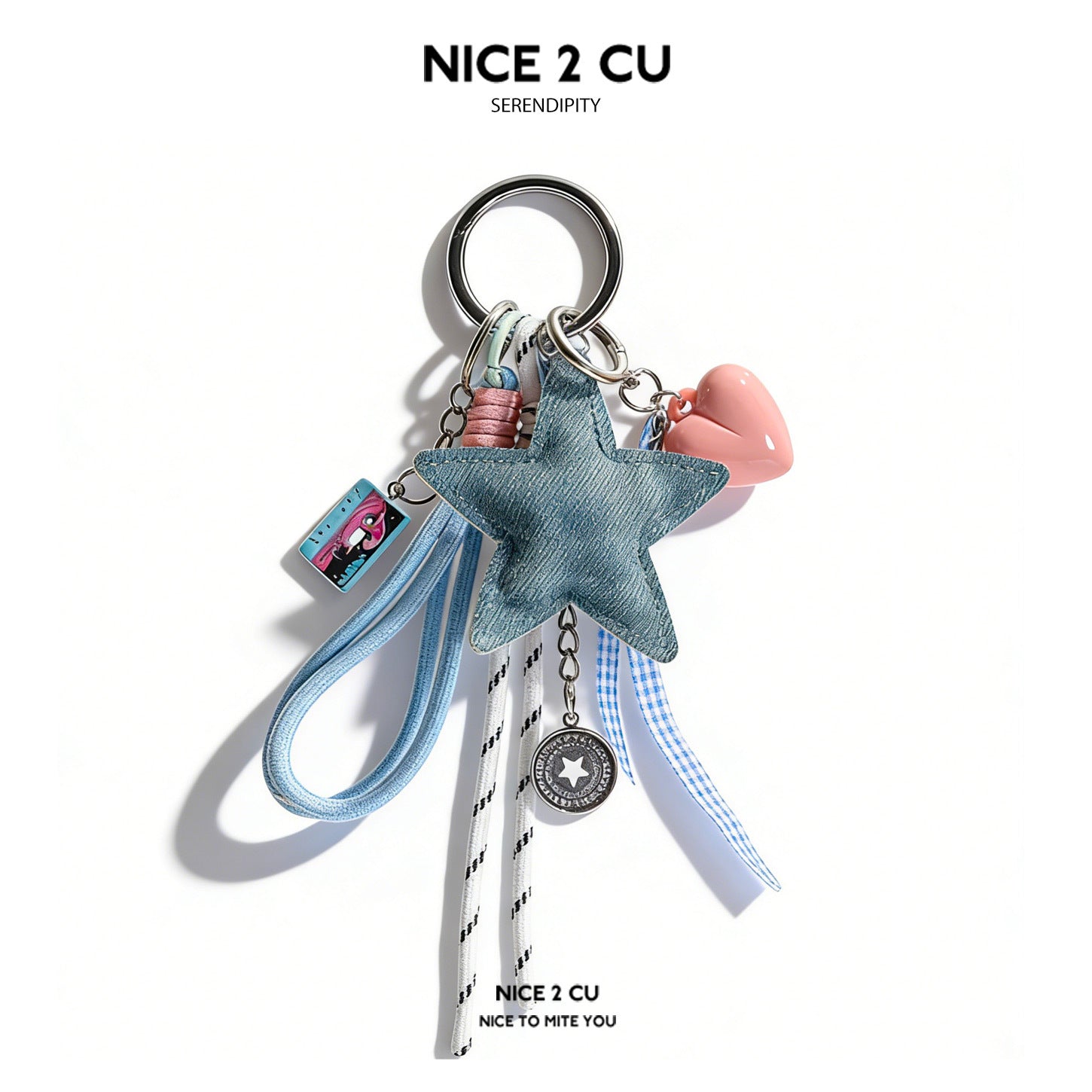 Denim blue padded star bag charm keychain with pink heart, silver medallion, gingham ribbon, and tassel pendants on silver sp