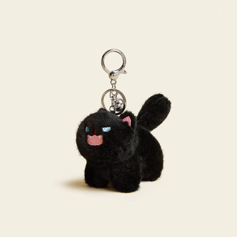Black frizzed-fur kawaii cat plush keychain charm with embroidered blue eyes, pink inner ears, fangs, and a silver bell clip