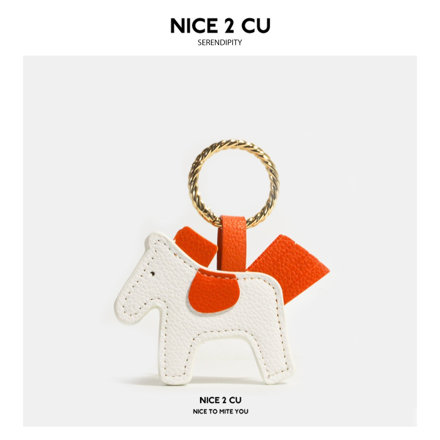 White and orange leather-look horse keychain charm with gold-tone ring and orange saddle detail