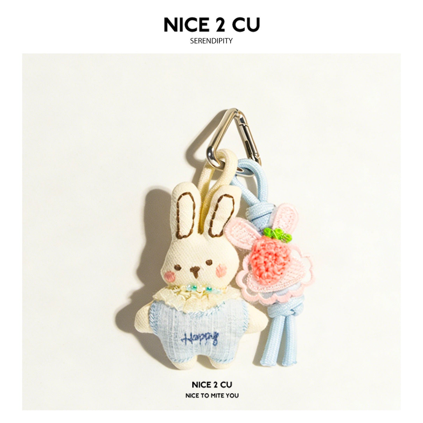 Cream fabric bunny charm in light blue knit outfit holding a pink crocheted flower bouquet with silver carabiner clip