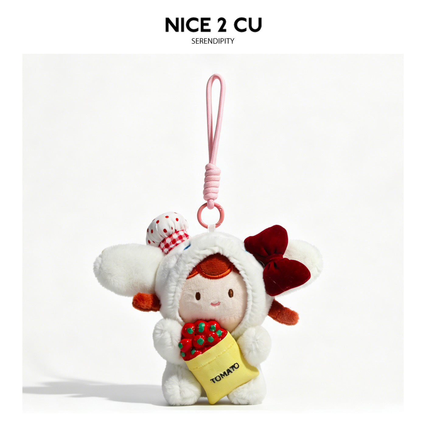 White kawaii plush doll charm in hooded costume with red bow and yellow tomato bag accessory
