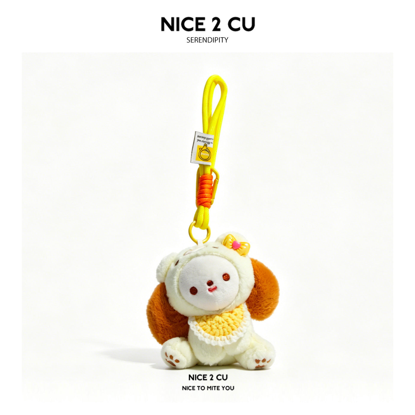 Cream kawaii milk dog plush keychain charm with yellow knitted bib, floppy ears, and bow, attached to braided cord with metal