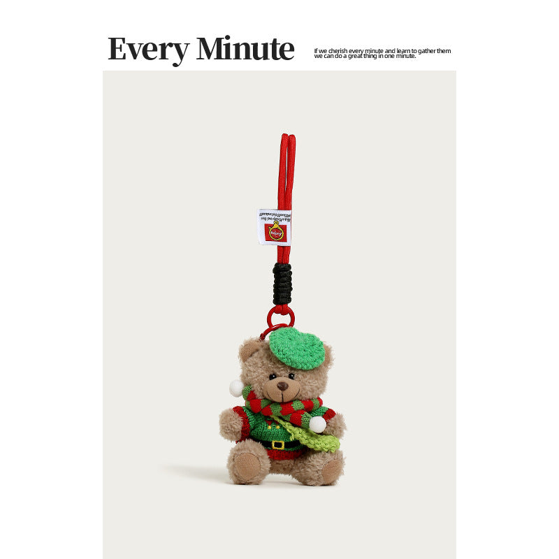 Brown plush bear hanging charm in green beret and festive red-and-green holiday sweater