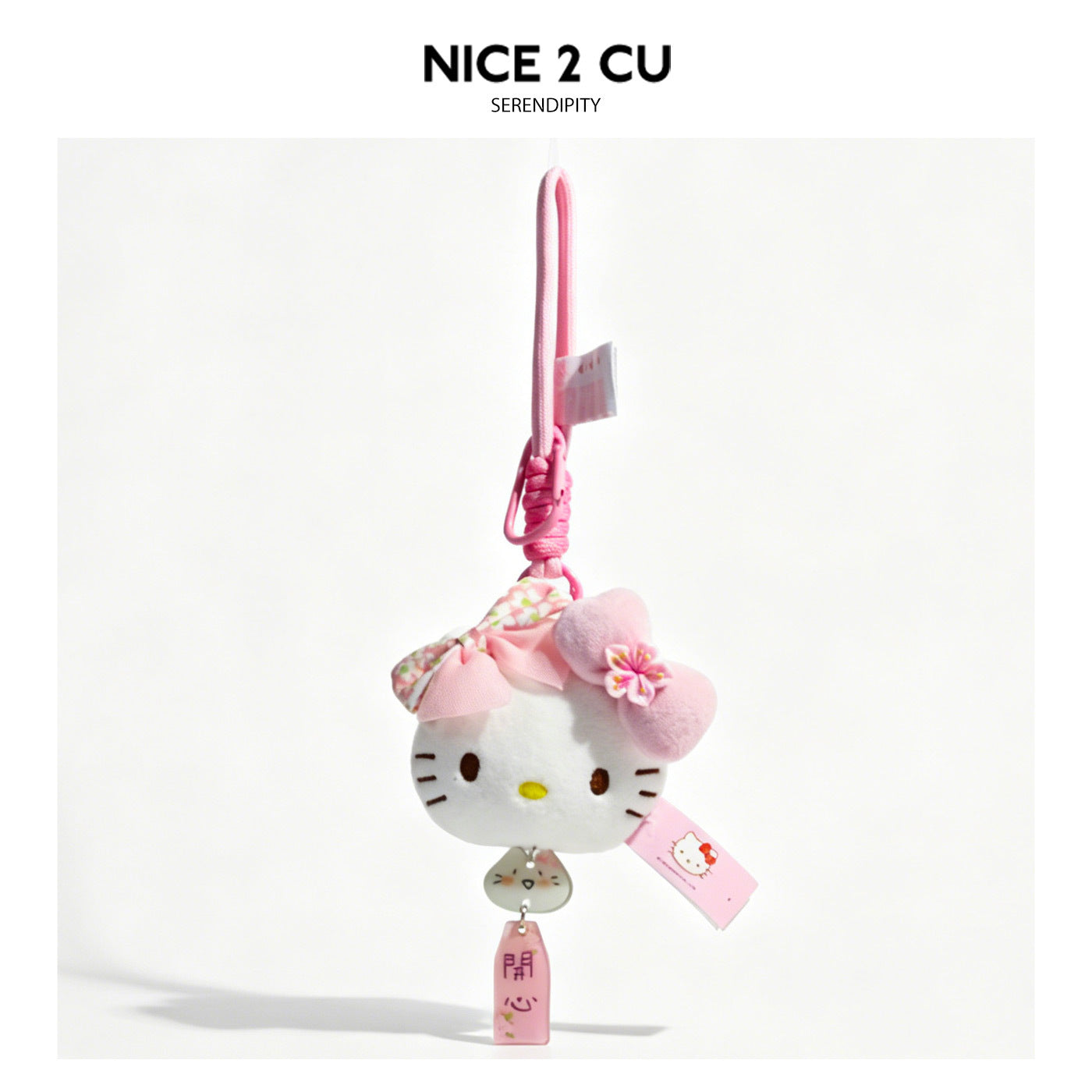 White cat-face plush charm keychain with pink bow accents and pink Happy tag on pink braided cord