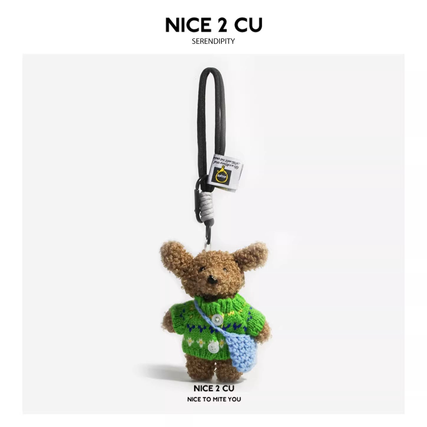 Fluffy teddy bear keychain charm in green buttoned sweater with light blue mini crossbody bag and black carabiner strap