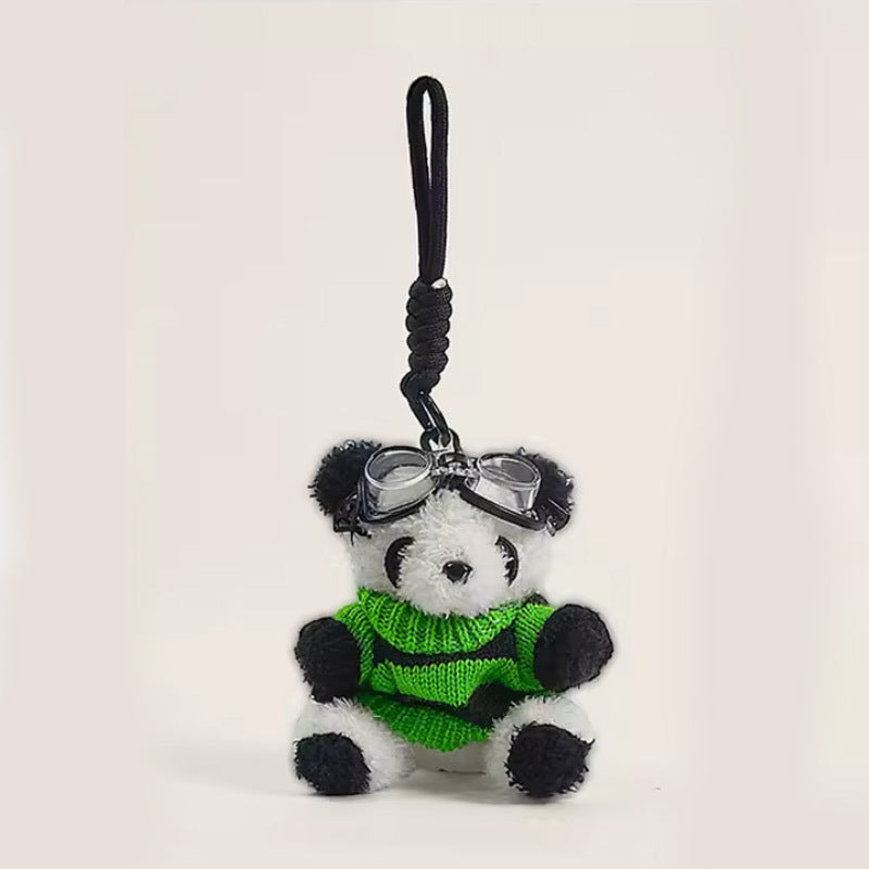 Panda plush bag charm in green and black sweater with decorative goggles and black hanging cord