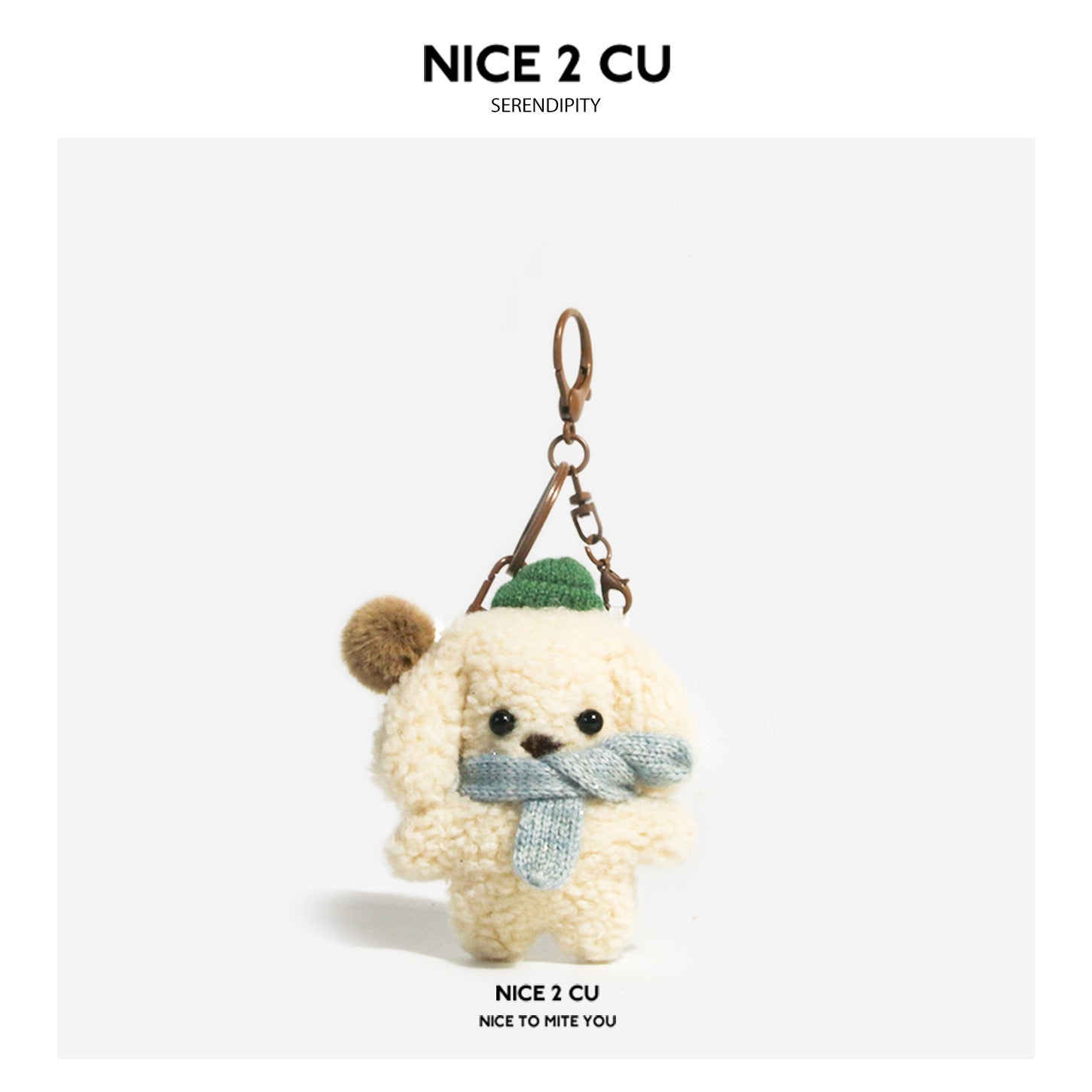 Curly cream and brown plush dog keychain charm with blue scarf and green hat accent