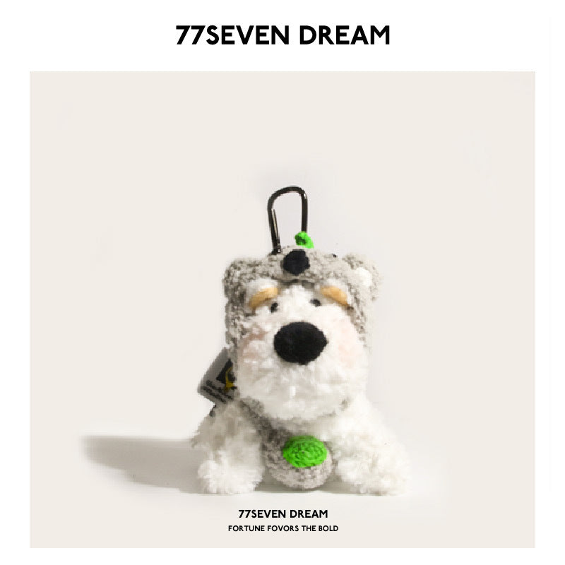 White fluffy dog plush charm wearing a gray koala costume hood with green accents and black strap