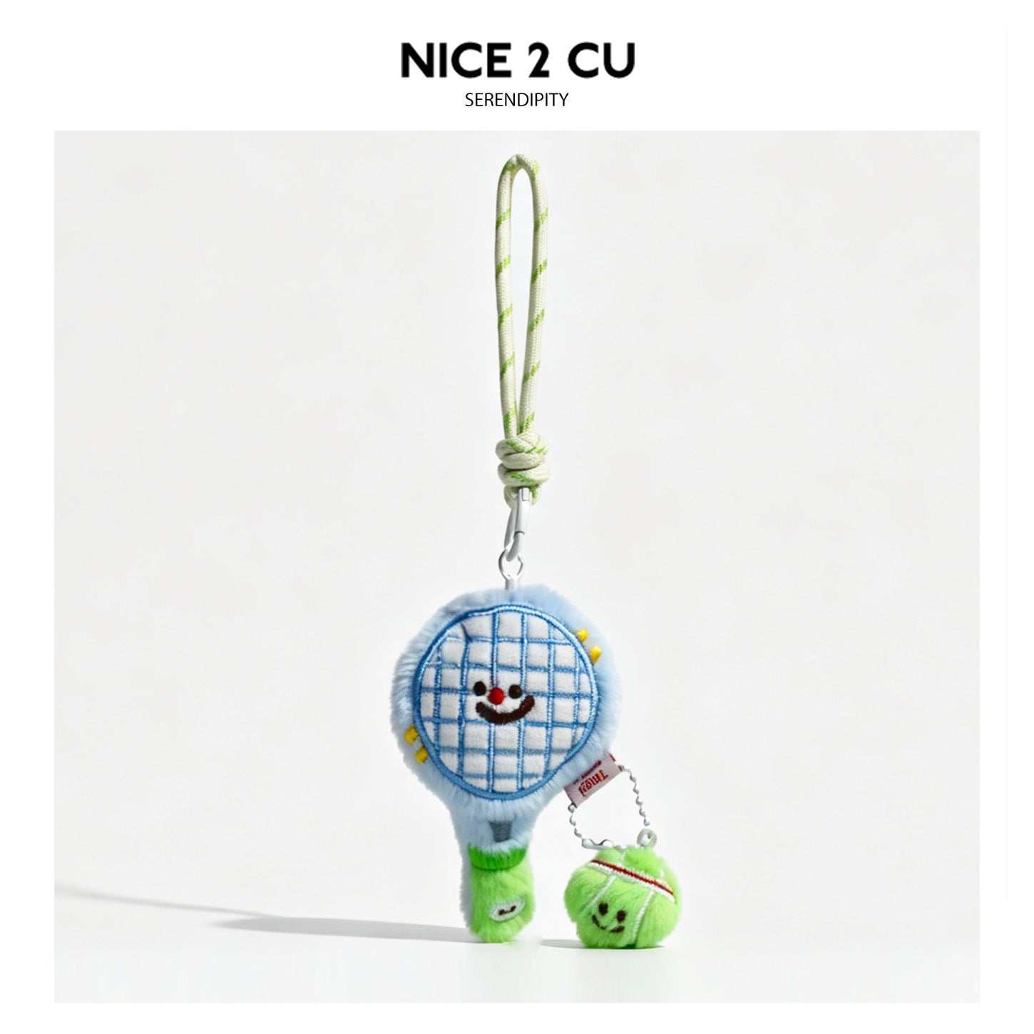 Blue kawaii tennis racket plush charm keychain with embroidered smiley face, green feet, and mini tennis ball pendant on silv