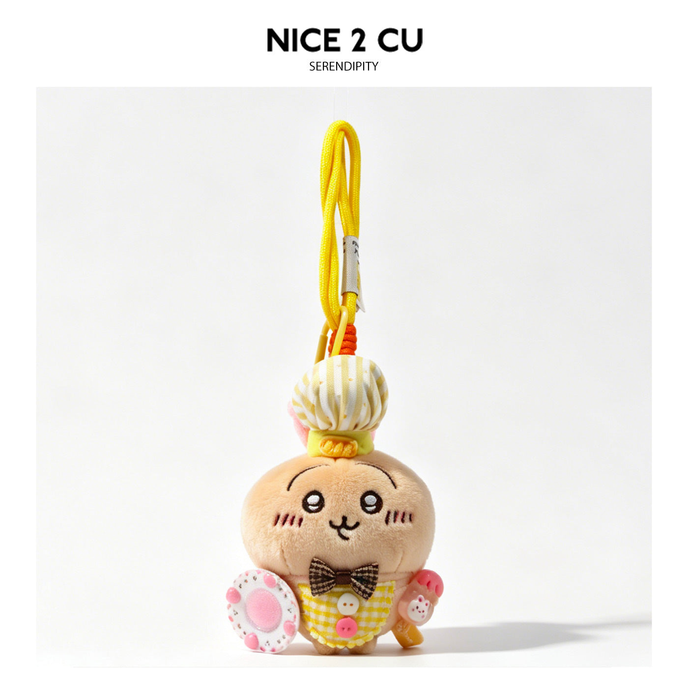 Kawaii cat plush keychain charm with white and yellow striped chef hat, yellow checkered outfit, and brown bow tie