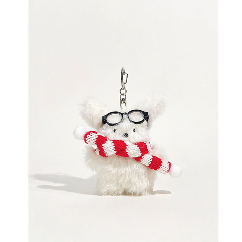 Fluffy white dog plush keychain charm with round black glasses and red-and-white striped scarf