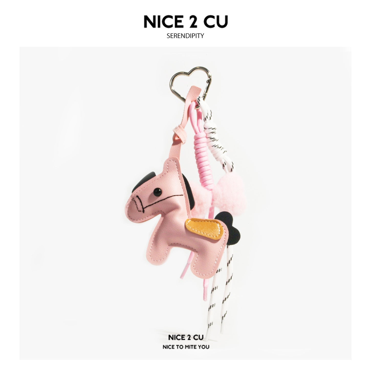 Pink horse-shaped bag charm keychain with black mane, yellow saddle patch, heart clip, and striped cord tassels