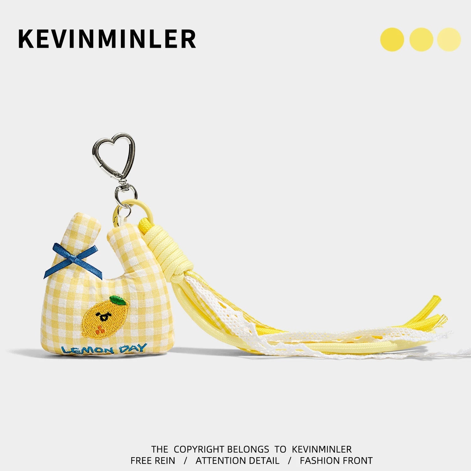 Yellow gingham mini tote bag charm with lemon embroidery, blue LEMON DAY text, yellow rope strap, and silver heart clip