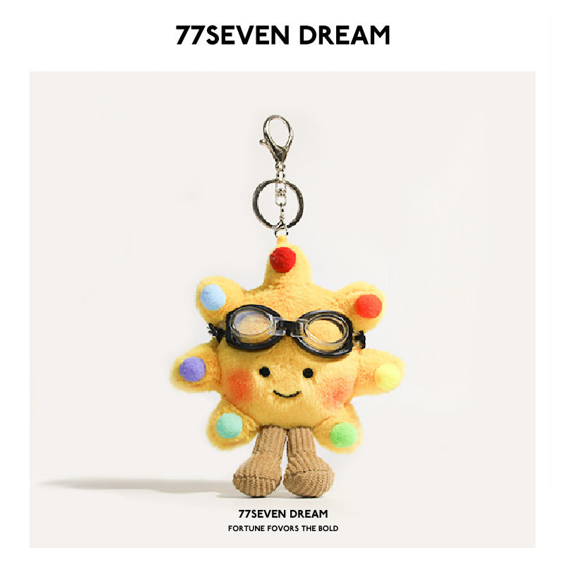 Yellow sunflower plush charm with black goggles and multicolored rainbow ball decorations around petals