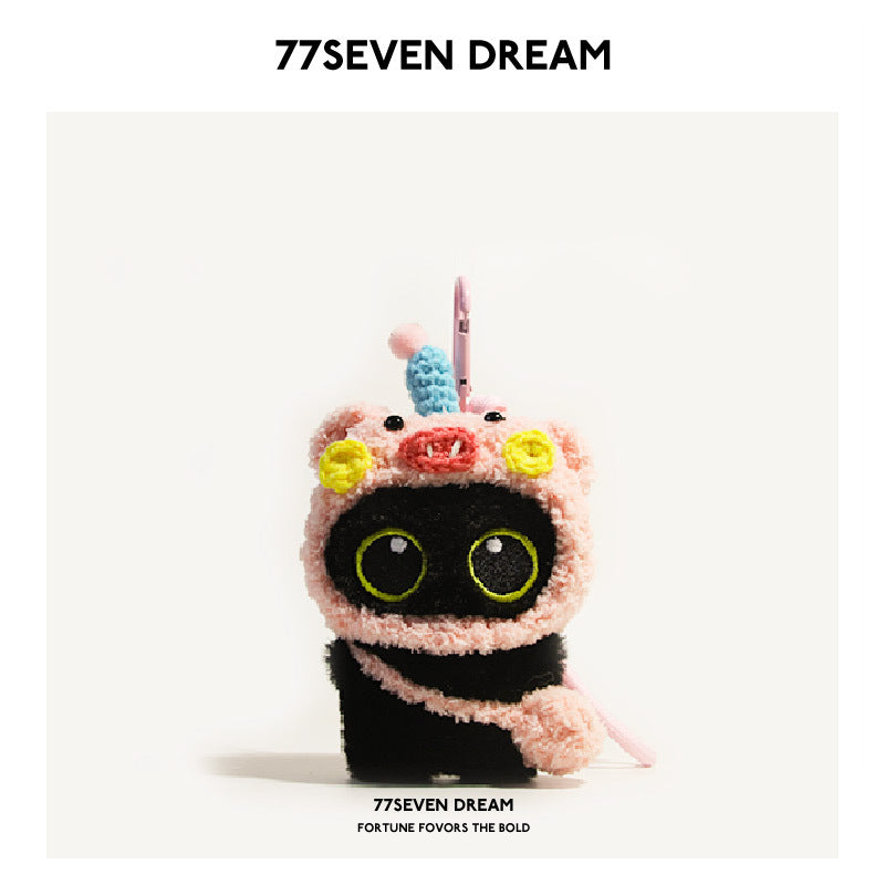 77SEVEN DREAM black cat plush charm wearing a pink pig hood with flower embellishments and carabiner clip