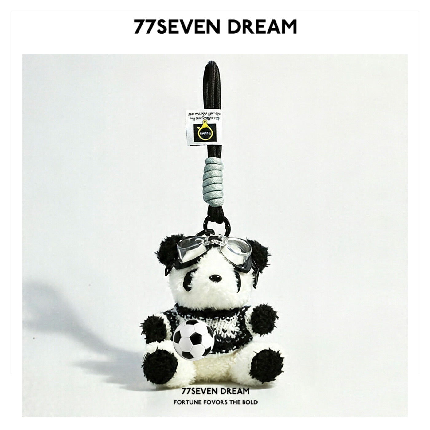 Panda plush keychain in a black-and-blue patterned knit sweater with clear goggles and miniature soccer ball