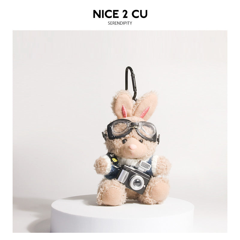 Brown plush rabbit keychain in blue-and-white knit sweater with aviator goggles and camera charm