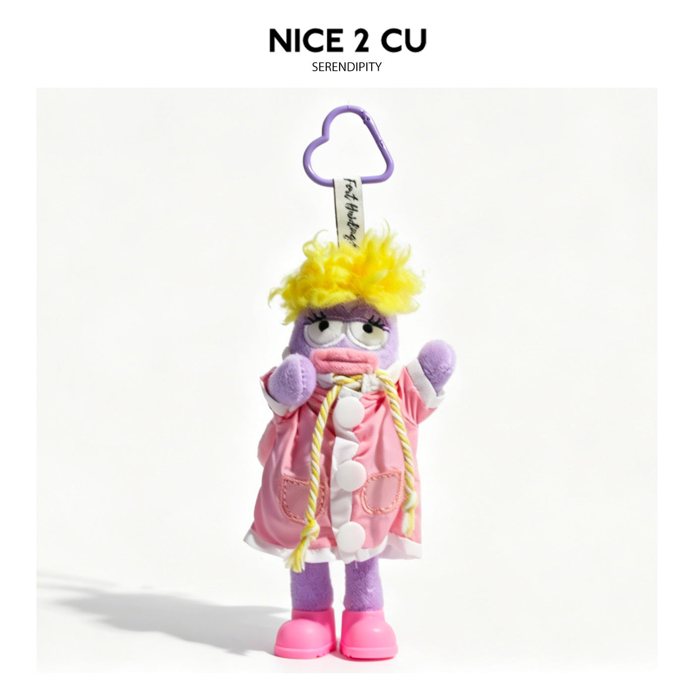 Purple cartoon plush keychain pendant in pink raincoat with white trim, rope tie, and pink shoes on purple heart-shaped carab