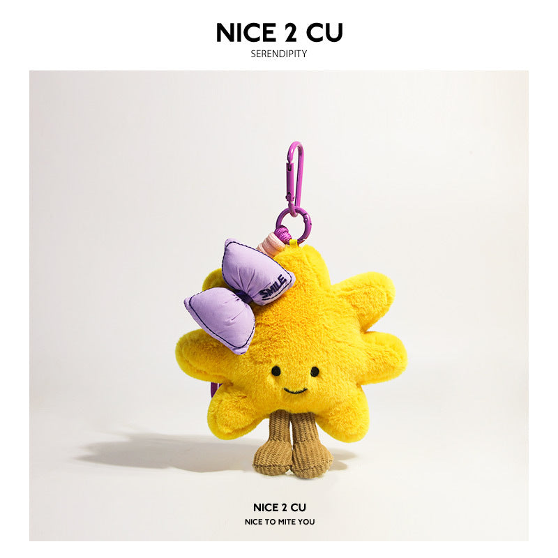 Yellow sunflower plush charm decorated with a lavender purple bow and purple-toned clip