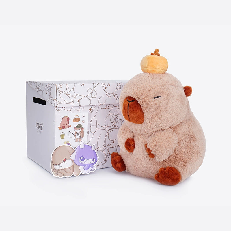 The ZEIO Capybara Plush Toy 25cm, a soft cuddly stuffed animal with a beret, sits beside a decorated box and two cartoon animal cutouts against a white background.