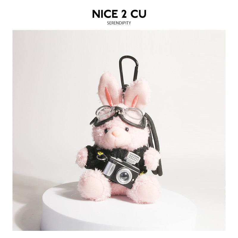 Pink plush rabbit keychain in black-and-white heart-pattern sweater with goggles and camera pendant