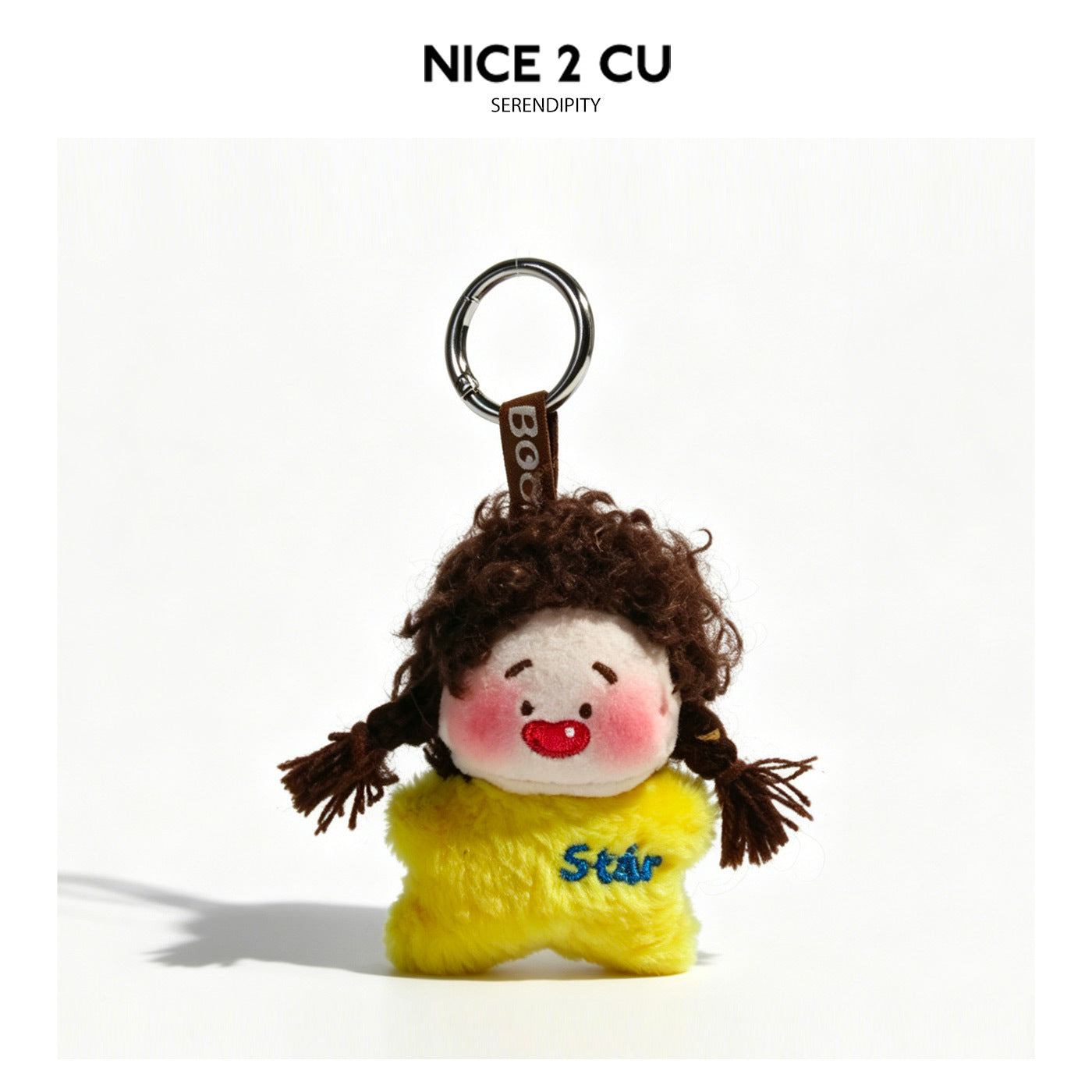 Yellow star-shaped plush keychain charm with curly brown hair, yarn pigtails, and embroidered Star text on body