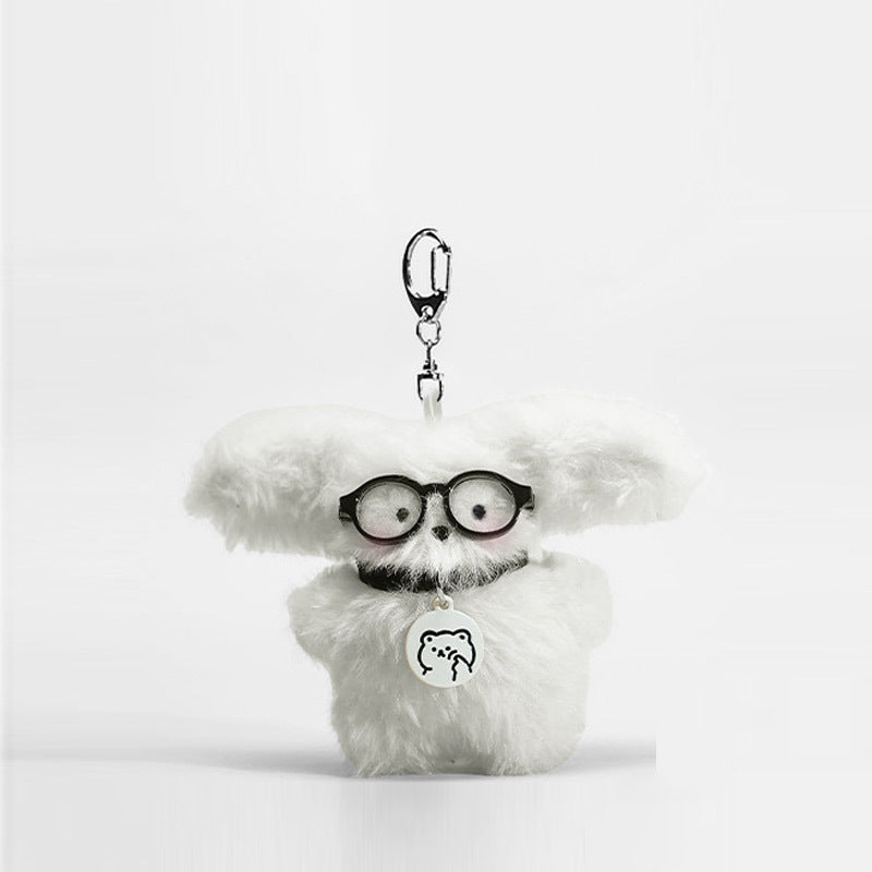 Fluffy white dog plush keychain charm with round black glasses and bear-face medallion pendant